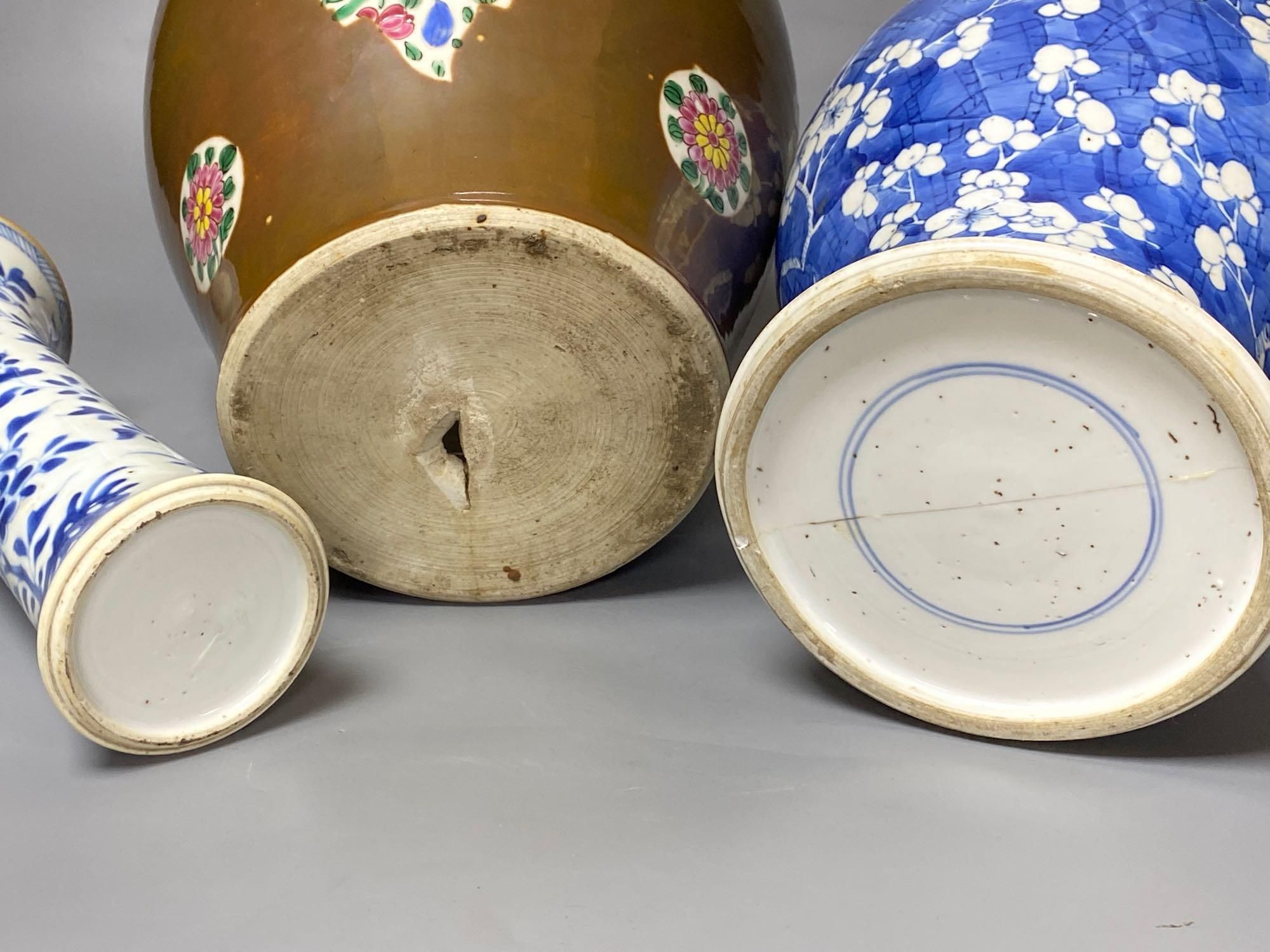 Two Chinese Kangxi period blue and white vases and a Qianlong Batavia vase and cover, largest 36cm high including the cover